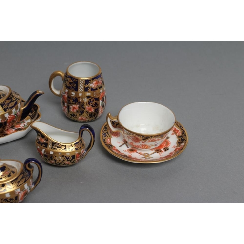 63 - A ROYAL CROWN DERBY CHINA THREE PIECE IMARI PATTERN MINIATURE TEA SERVICE, 1919, with prow teapot, t... 