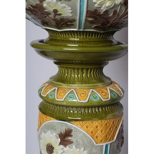 66 - A BURMANTOFTS FAIENCE JARDINIERE AND STAND, early 20th century, moulded and decorated in shades of y... 