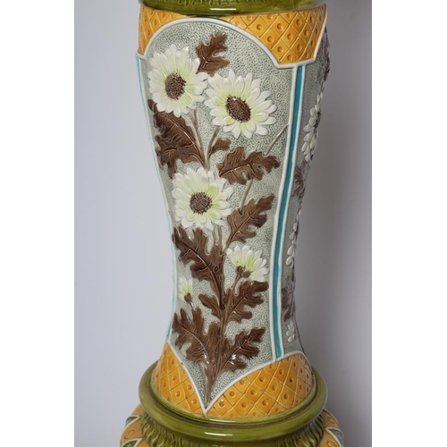 66 - A BURMANTOFTS FAIENCE JARDINIERE AND STAND, early 20th century, moulded and decorated in shades of y... 