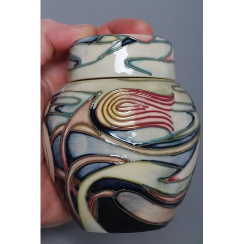 79 - A MOORCROFT POTTERY SMALL JAR AND COVER, 2003, of ovoid form, tubelined and painted in colours with ... 