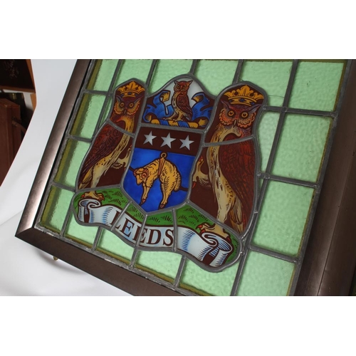 455 - A STAINED GLASS PANEL DEPICTING THE ARMS OF THE CITY OF LEEDS, 20th century, within a plain green gl... 