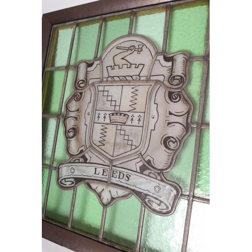 455 - A STAINED GLASS PANEL DEPICTING THE ARMS OF THE CITY OF LEEDS, 20th century, within a plain green gl... 