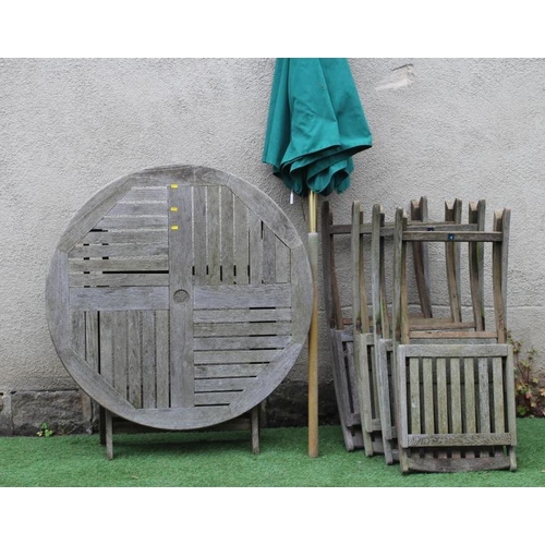 459 - A TEAK TABLE AND CHAIRS, manufactured by Neptune, the folding circular slatted table 42 1/2