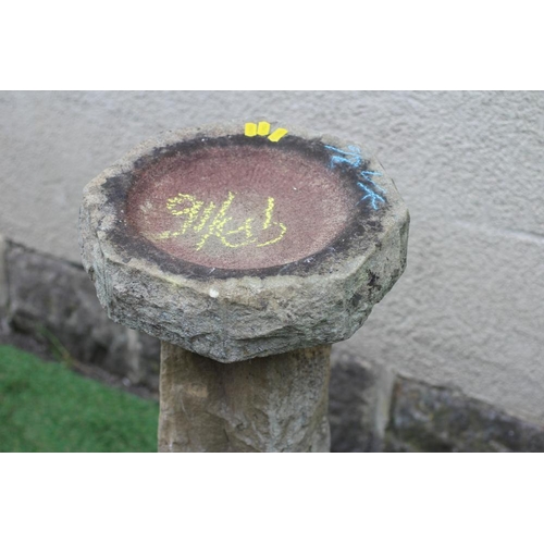 465 - A SANDSTONE BIRD BATH, the rough hewn octagonal bowl raised on square tapering stem and octagonal ba... 