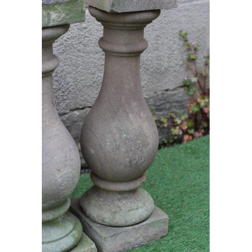 488 - A SET OF FOUR CARVED SANDSTONE BALUSTERS, 19th century, with square capitals and plinths, 8