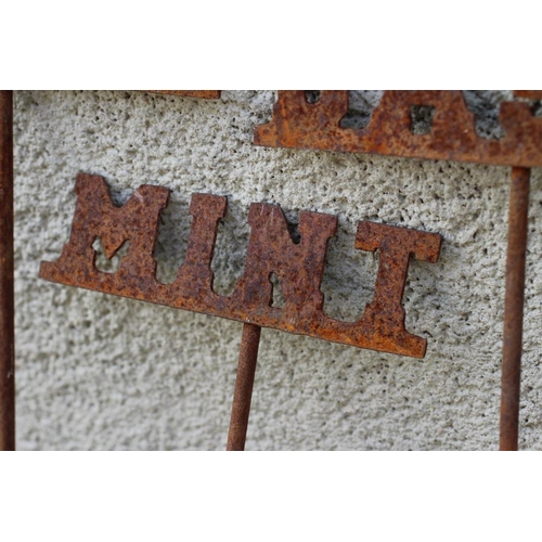 489 - A SET OF TEN RECLAIMED METAL HERB LABELS, each on a turned post with rust patination, 6