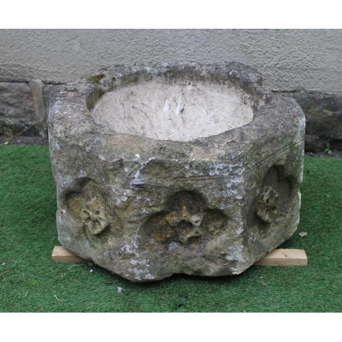 500 - A SUBSTANTIAL SANDSTONE PLANTER, 19th century, of deep circular form carved with a band of flowerhea... 