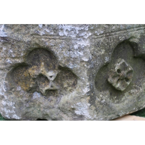 500 - A SUBSTANTIAL SANDSTONE PLANTER, 19th century, of deep circular form carved with a band of flowerhea... 