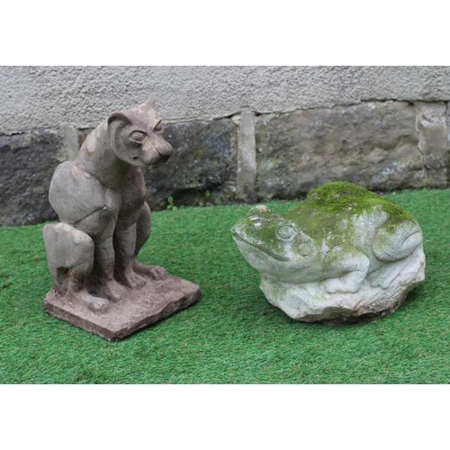 504 - A CARVED SANDSTONE MODEL OF A WILD CAT seated on a rustic oblong base, 8 1/2