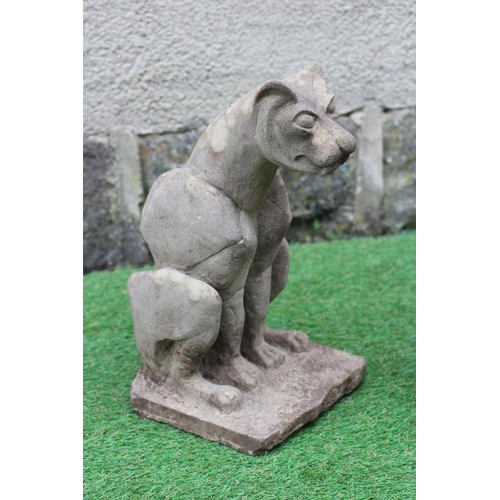 504 - A CARVED SANDSTONE MODEL OF A WILD CAT seated on a rustic oblong base, 8 1/2