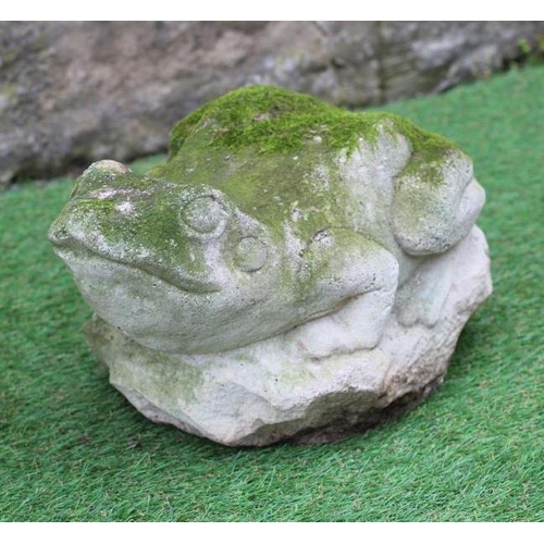 504 - A CARVED SANDSTONE MODEL OF A WILD CAT seated on a rustic oblong base, 8 1/2