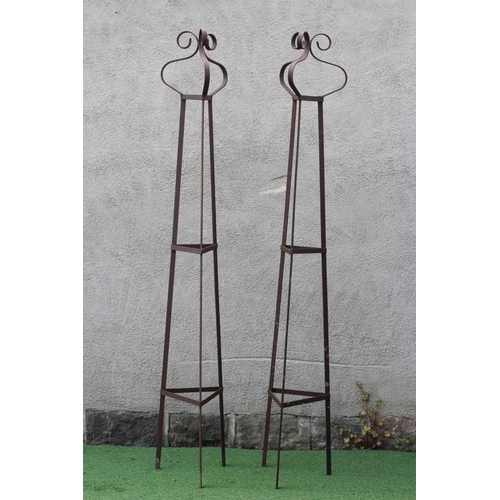 506 - A PAIR OF WROUGHT IRON PLANT OBELISKS of tapering triangular form with scroll finials, rust patinati... 