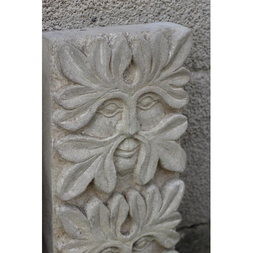 509 - A PAIR OF CARVED SANDSTONE GREEN MAN WALL PANELS of oblong form each with three masks, 8