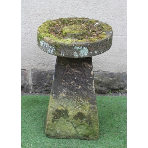 510 - A SANDSTONE BIRD BATH, the circular top with central boss raised on a square tapering stem, 19 1/2