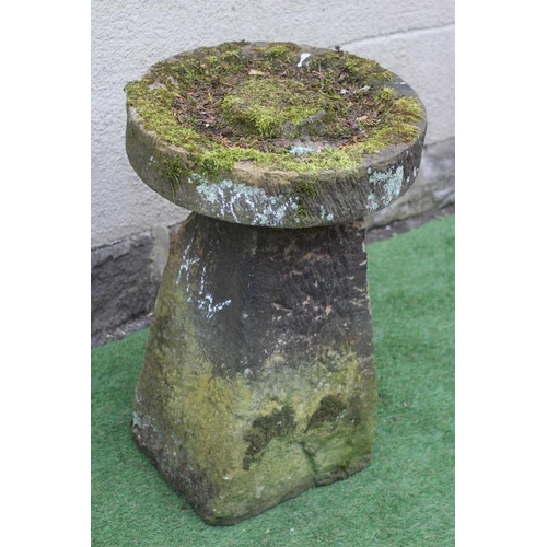 510 - A SANDSTONE BIRD BATH, the circular top with central boss raised on a square tapering stem, 19 1/2