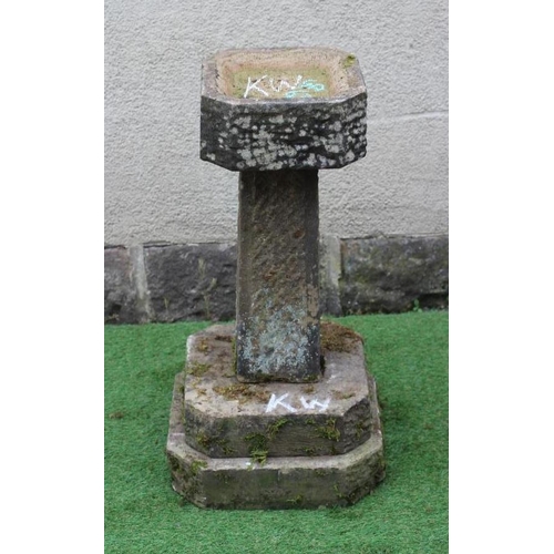 512 - A SANDSTONE BIRD BATH, the finely cut canted square basin raised on tapering stem and stepped canted... 