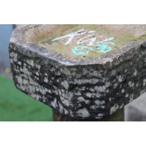 512 - A SANDSTONE BIRD BATH, the finely cut canted square basin raised on tapering stem and stepped canted... 