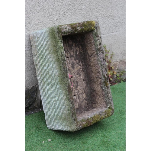 516 - A SANDSTONE TROUGH of well cut oblong form with line banding, 27 1/2