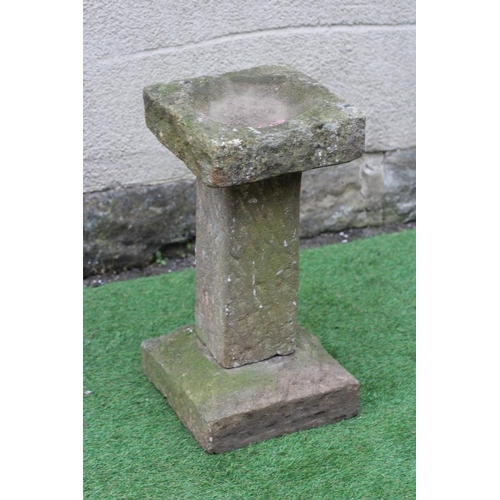 518 - A SANDSTONE BIRD BATH of rough hewn square form, 12