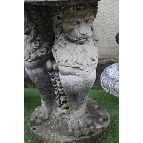 522 - A CAST STONE TABLE, the circular top with ovolu rim on lion monopodiae supports and circular base, 3... 