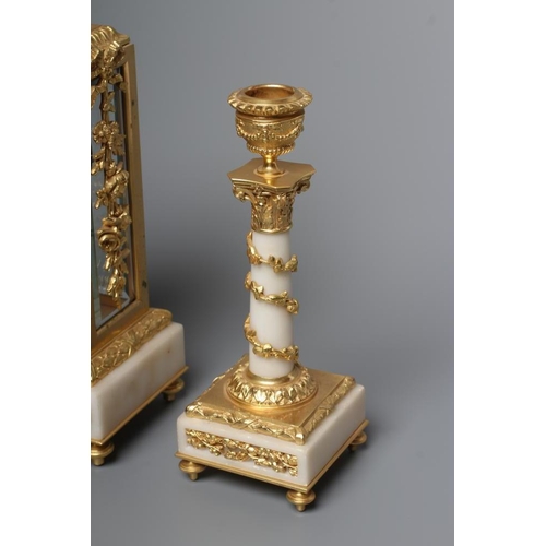 562 - A GILT METAL AND ALABASTER CLOCK GARNITURE, modern, the twin barrel movement with platform escapemen... 