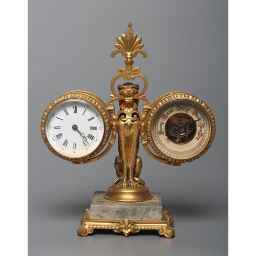 563 - A GILT METAL FIGURAL DESK COMPENDIUM, c.1900, comprising a clock and barometer suspended from a scro... 