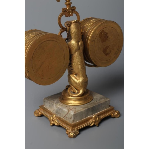 563 - A GILT METAL FIGURAL DESK COMPENDIUM, c.1900, comprising a clock and barometer suspended from a scro... 