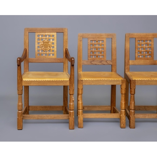 590 - A ROBERT THOMPSON SET OF SIX OAK DINING CHAIRS including two elbow chairs, with pierced lattice back... 