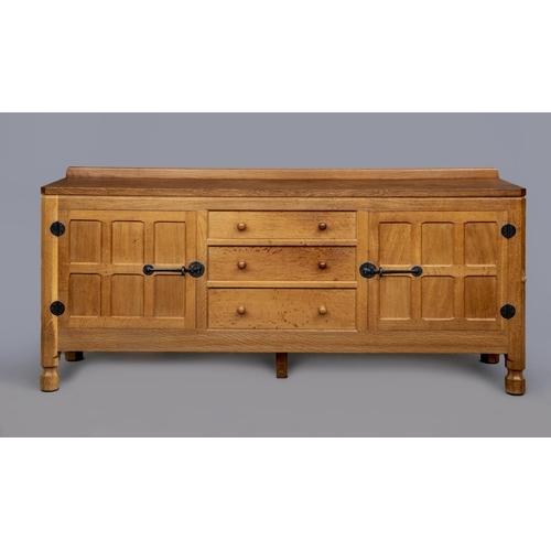 591 - A ROBERT THOMPSON ADZED OAK ENCLOSED DRESSER, the moulded edged top with ledge back, three centre dr... 