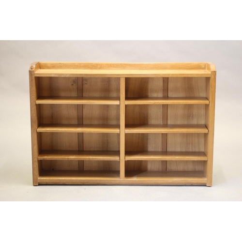 599 - A ROBERT THOMPSON ADZED OAK OPEN BOOKCASE of oblong form with three quarter galleried top, three adj... 