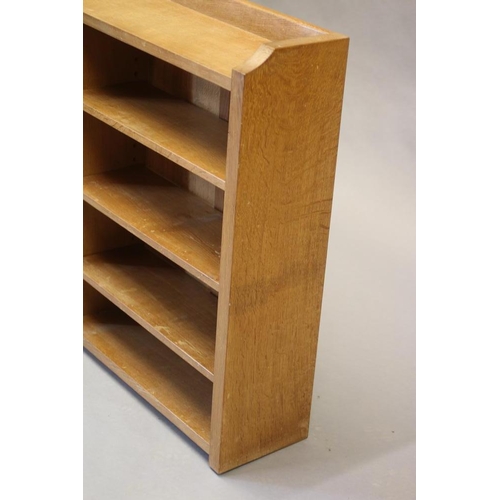 599 - A ROBERT THOMPSON ADZED OAK OPEN BOOKCASE of oblong form with three quarter galleried top, three adj... 