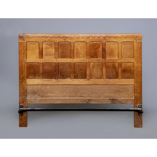 603 - A ROBERT THOMPSON ADZED OAK DOUBLE BEDSTEAD, the multi-panelled headboard with half penny moulded co... 