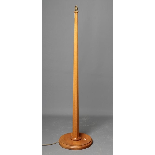 606 - AN OAK STANDARD LAMP BY GEOFF GELL OF COXWOLD, the tapering faceted stem on on moulded edged dished ... 