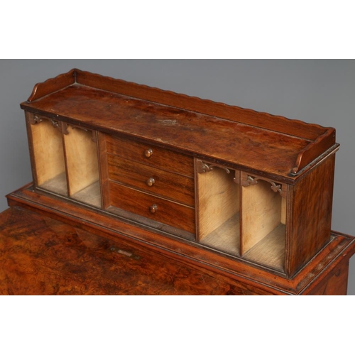 613 - A VICTORIAN BURR WALNUT DAVENPORT, the rise and fall stationery compartment with drawers and pigeon ... 