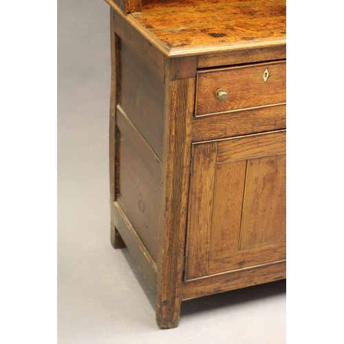 615 - A GEORGIAN OAK ENCLOSED DRESSER c.1800, the delft rack with moulded cornice over reeded frieze and t... 