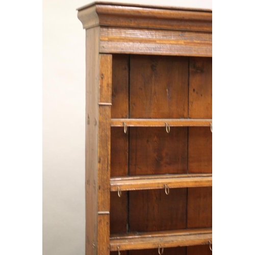 615 - A GEORGIAN OAK ENCLOSED DRESSER c.1800, the delft rack with moulded cornice over reeded frieze and t... 