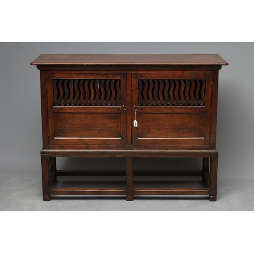 619 - A JOINED OAK LIVERY CUPBOARD, early 18th century and later, the moulded edged top over a pair of twi... 