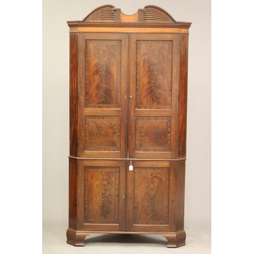 621 - A GEORGIAN MAHOGANY STANDING CORNER CUPBOARD, c.1800, the moulded cornice with scrolled surmount cen... 