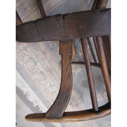 626 - A COMB BACK WINDSOR ARMCHAIR, Welsh 18th century, with curved top rail, shaped tapering arm supports... 