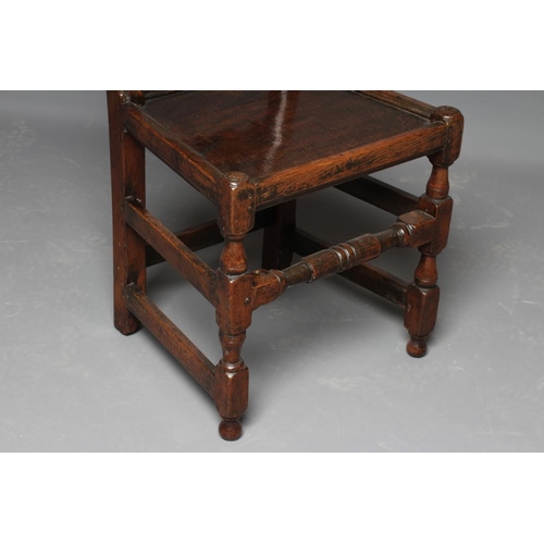 627 - A JOINED OAK BACKSTOOL, c.1700, the square uprights with pointed finials enclosing an arched leaf an... 