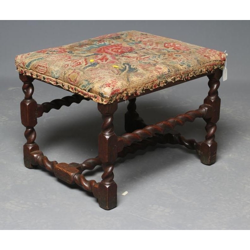 629 - AN JOINED OAK STOOL, late 17th century, the oblong seat with contemporary Turkey work, on wrythen tu... 