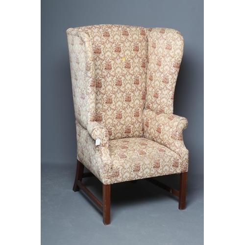 644 - A GEORGIAN DESIGN MAHOGANY AND ELM FRAMED WING ARMCHAIR, 19th century, upholstered in a cream and pi... 