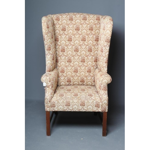 644 - A GEORGIAN DESIGN MAHOGANY AND ELM FRAMED WING ARMCHAIR, 19th century, upholstered in a cream and pi... 