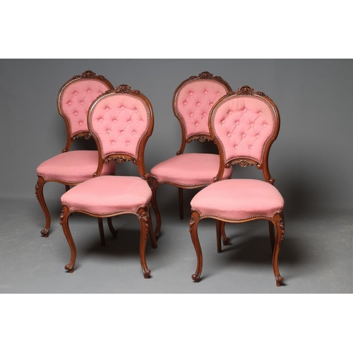 652 - A SET OF FOUR VICTORIAN WALNUT BALLOON BACK SALON CHAIRS button upholstered in a pink weave, the cha... 