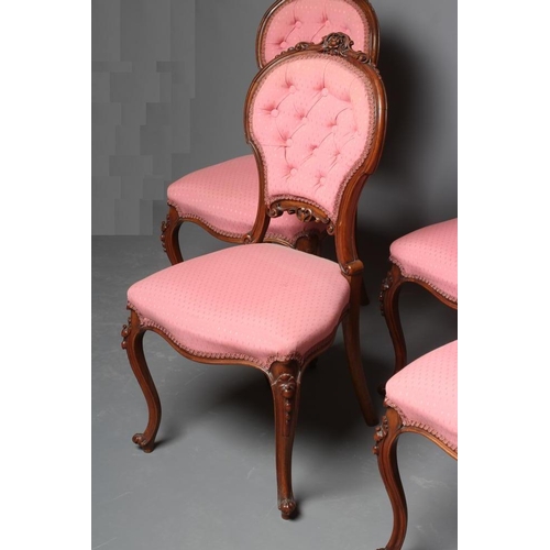 652 - A SET OF FOUR VICTORIAN WALNUT BALLOON BACK SALON CHAIRS button upholstered in a pink weave, the cha... 