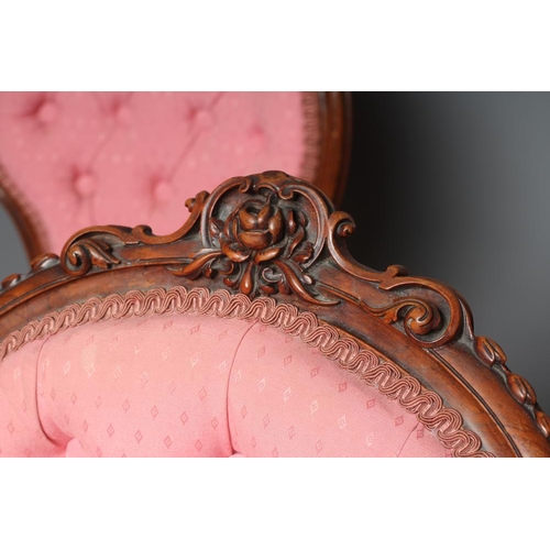 652 - A SET OF FOUR VICTORIAN WALNUT BALLOON BACK SALON CHAIRS button upholstered in a pink weave, the cha... 