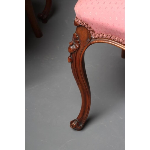 652 - A SET OF FOUR VICTORIAN WALNUT BALLOON BACK SALON CHAIRS button upholstered in a pink weave, the cha... 