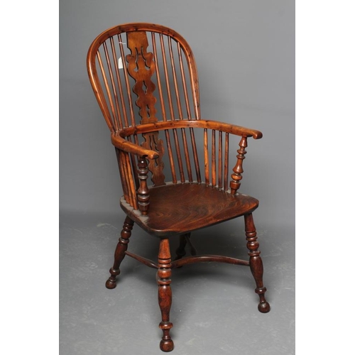 653 - A YORKSHIRE YEW HIGH BACK WINDSOR ARMCHAIR, late 19th century, the hooped back with shaped and pierc... 