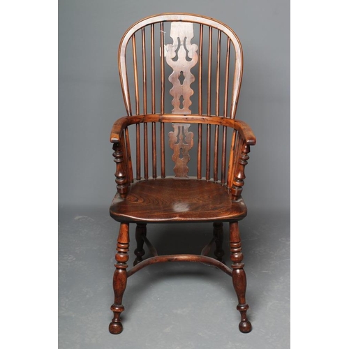 653 - A YORKSHIRE YEW HIGH BACK WINDSOR ARMCHAIR, late 19th century, the hooped back with shaped and pierc... 