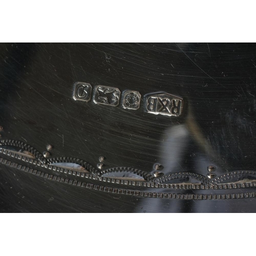 125 - A CIRCULAR GALLERIED TRAY, maker Roberts & Belk, Sheffield 1978, with cast and applied bead rim over... 